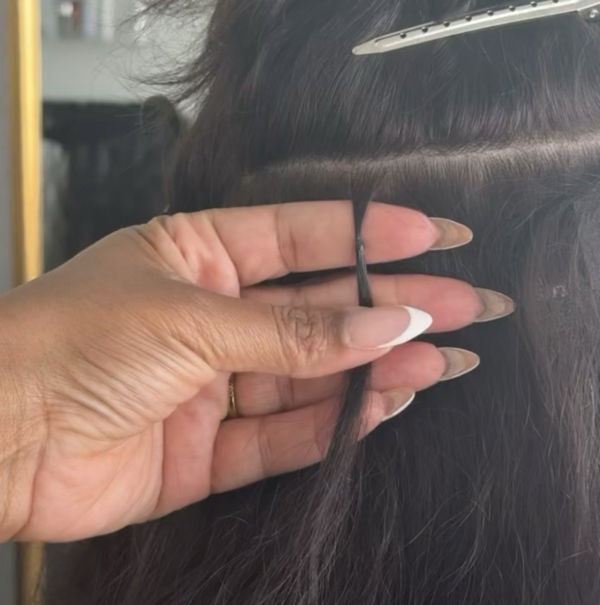 Kiya placing an individual K-tip keratin bond extension at The Label Salon in Longwood, FL